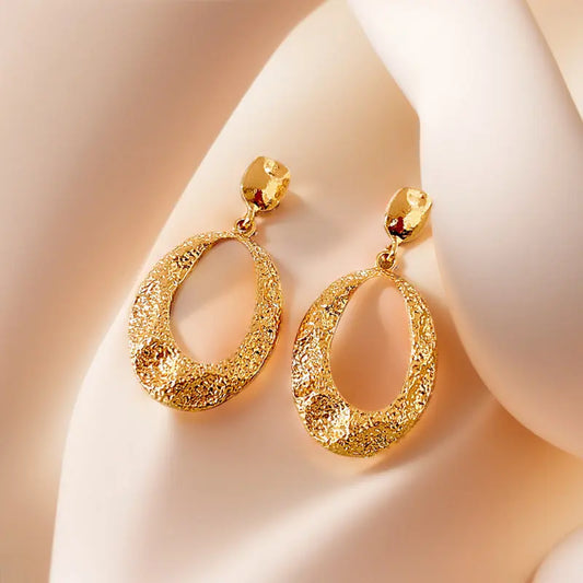 Golden teardrop earrings with intricate detailing