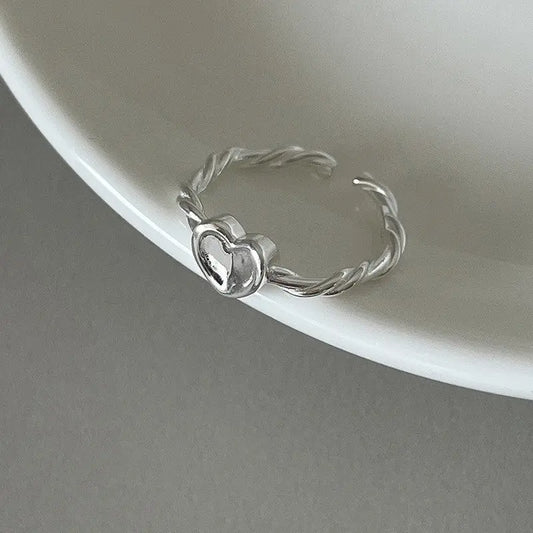 Delicate silver ring with heart detail