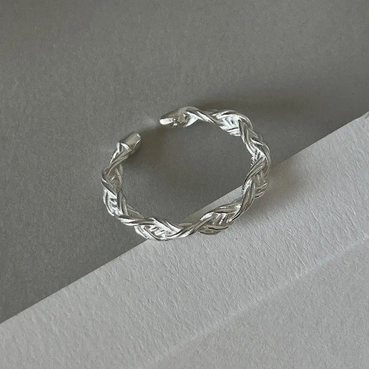 Braided silver ring with intricate design